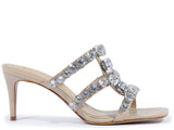 Three-quarter view of a Schutz crystal-embellished nude sandal, showing the brilliant sparkle of the gemstones and the branded footbed.
