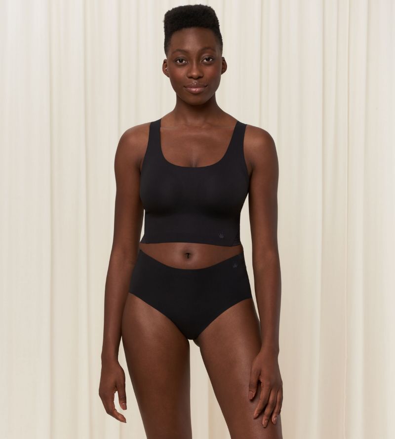 Second Model full front view of the Triumph Flex Smart black pull-on bra top, highlighting the smooth neckline and flexible, wire-free design. Order Online Today