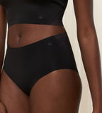 Second model close-up view of the Triumph Flex Smart black maxi panty, highlighting the high-waisted coverage and smooth, seamless fabric. Available Online at Blue Salon Qatar