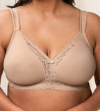 Second model close-up view of the Triumph Modern Lace+Cotton beige non-wired bra, showcasing the cotton cups and decorative floral lace. Shop the Latest Online