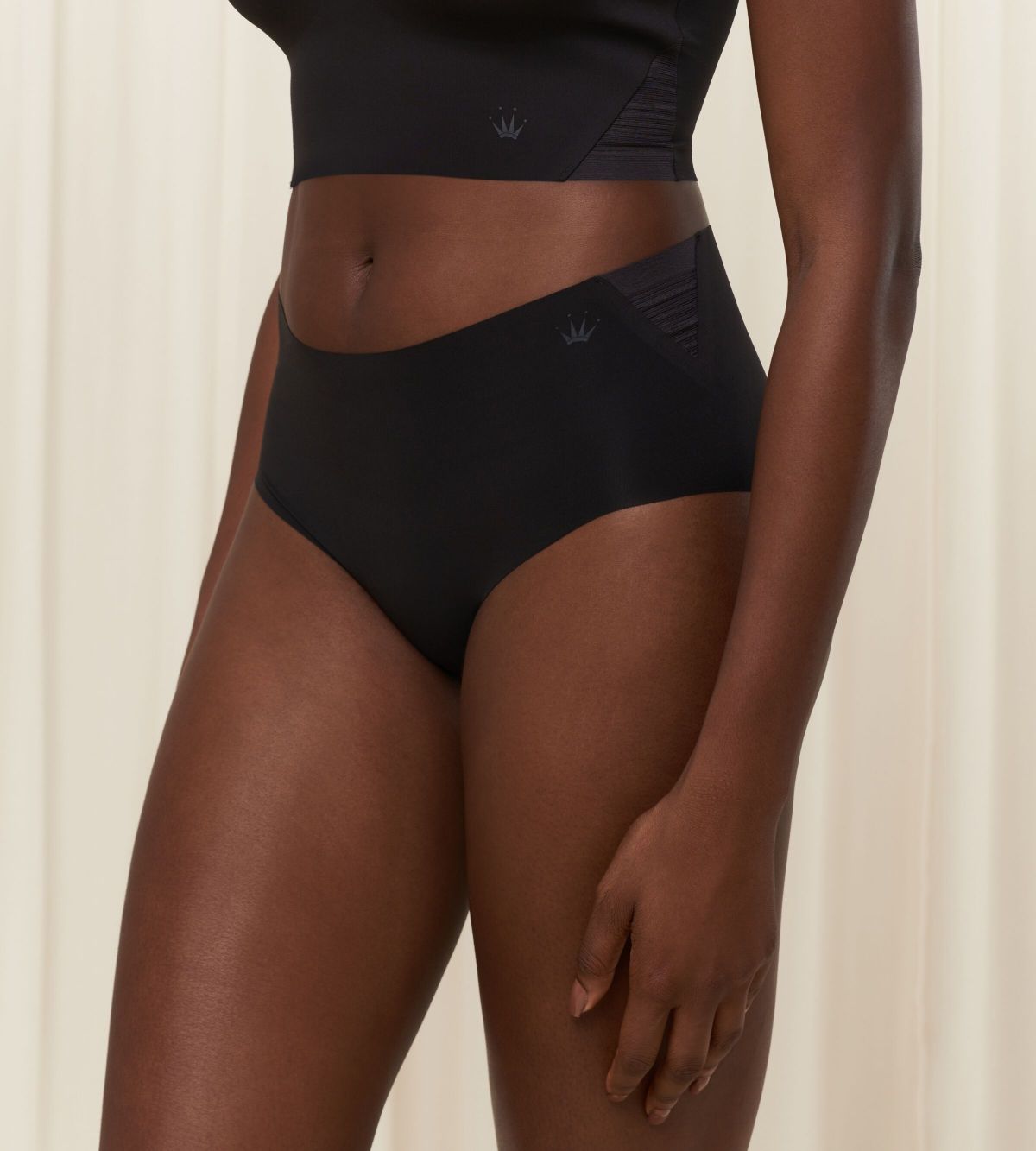 Second model front view of the Triumph Flex Smart black maxi panty, highlighting the high-waisted coverage and smooth, seamless fabric. Available Online at Blue Salon Qatar