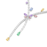 A detailed close-up shot of the Ariana Grande x Swarovski necklace centerpiece, showcasing the intricate setting of the pink and purple dragonfly wings, the floating blue, yellow, and violet crystals, and the cascading clear strands.