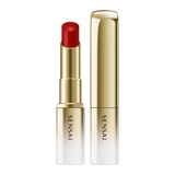 Sensai lipstick with red shade and gold casing on a white background.