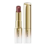 Sensai lipstick with gold casing on a white background.