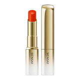 Sensai lipstick with red cap and gold casing on a white background.