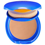 Shiseido UV Protective Compact Foundation in a blue compact case with a mirror on the lid, showing the foundation and the sponge applicator.