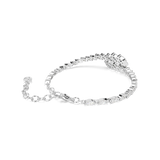 A side perspective studio shot of the Swarovski Mesmera bracelet draped on a white surface, showcasing the fluid link structure, lobster claw closure, and the dimensional elevation of the central crystal cluster.
