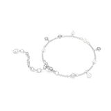 A side perspective view of the Swarovski Imber bracelet draped on a flat surface, showcasing the fluid movement of the silver-tone link chain and the dangling pearl and crystal charms.