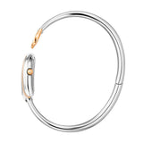 A side-angle studio shot profile of the Aigner Flora women's watch, displaying the slim profile of the horseshoe case, the knurled rose gold-tone adjustment crown, and the perfect circular geometry of the silver-tone bangle bracelet.