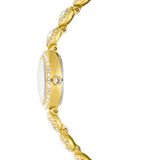 A crisp side profile view of the Swarovski Una Angelic watch, illustrating the polished gold-tone finish of the watch case, the thickness of the pave bezel, and the single clear crystal embedded in the crown.
