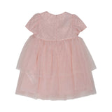 Back view of the Simonetta pink tulle dress showing the tiered layers and a concealed central zipper.