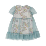 Back view of the Simonetta tulle floral dress showing the ruffle hem, empire waist, and keyhole button fastening.