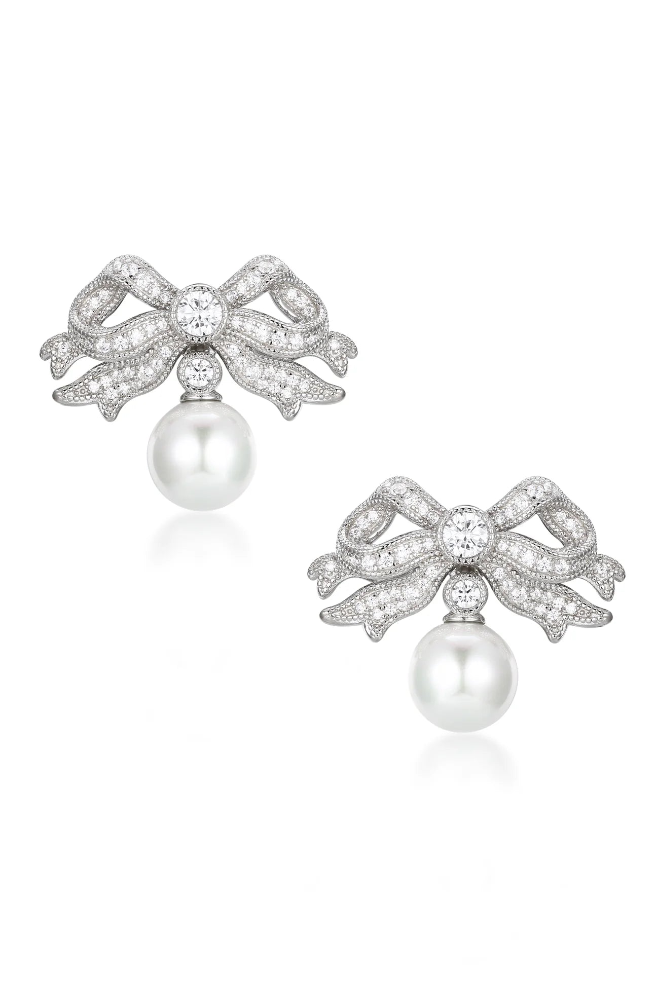 Pair of silver-toned bow earrings with clear stones and white pearl drops.
