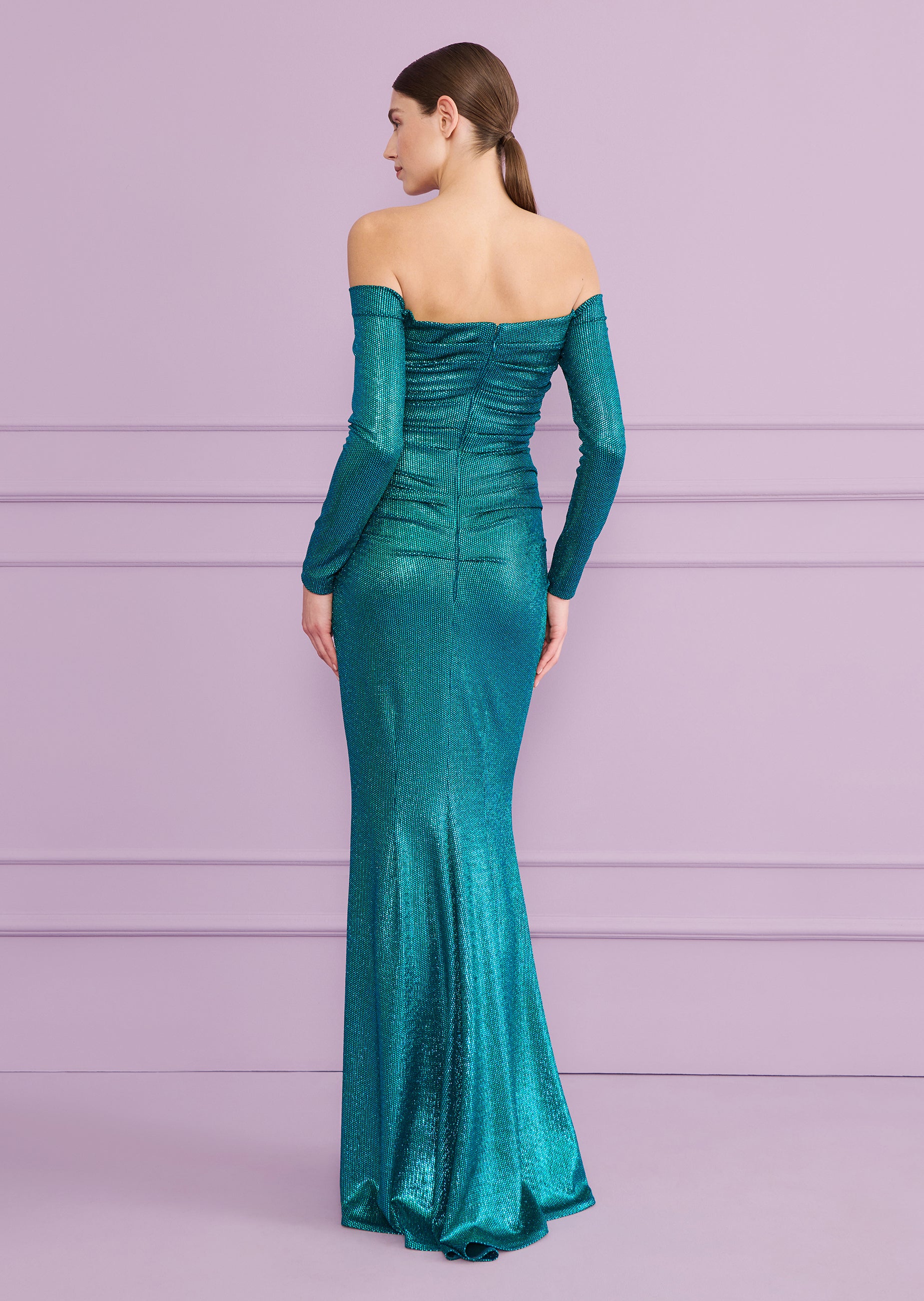 Shimmery teal knit long off-shoulder dress with ruched back bodice, long sleeves, and a mermaid skirt.