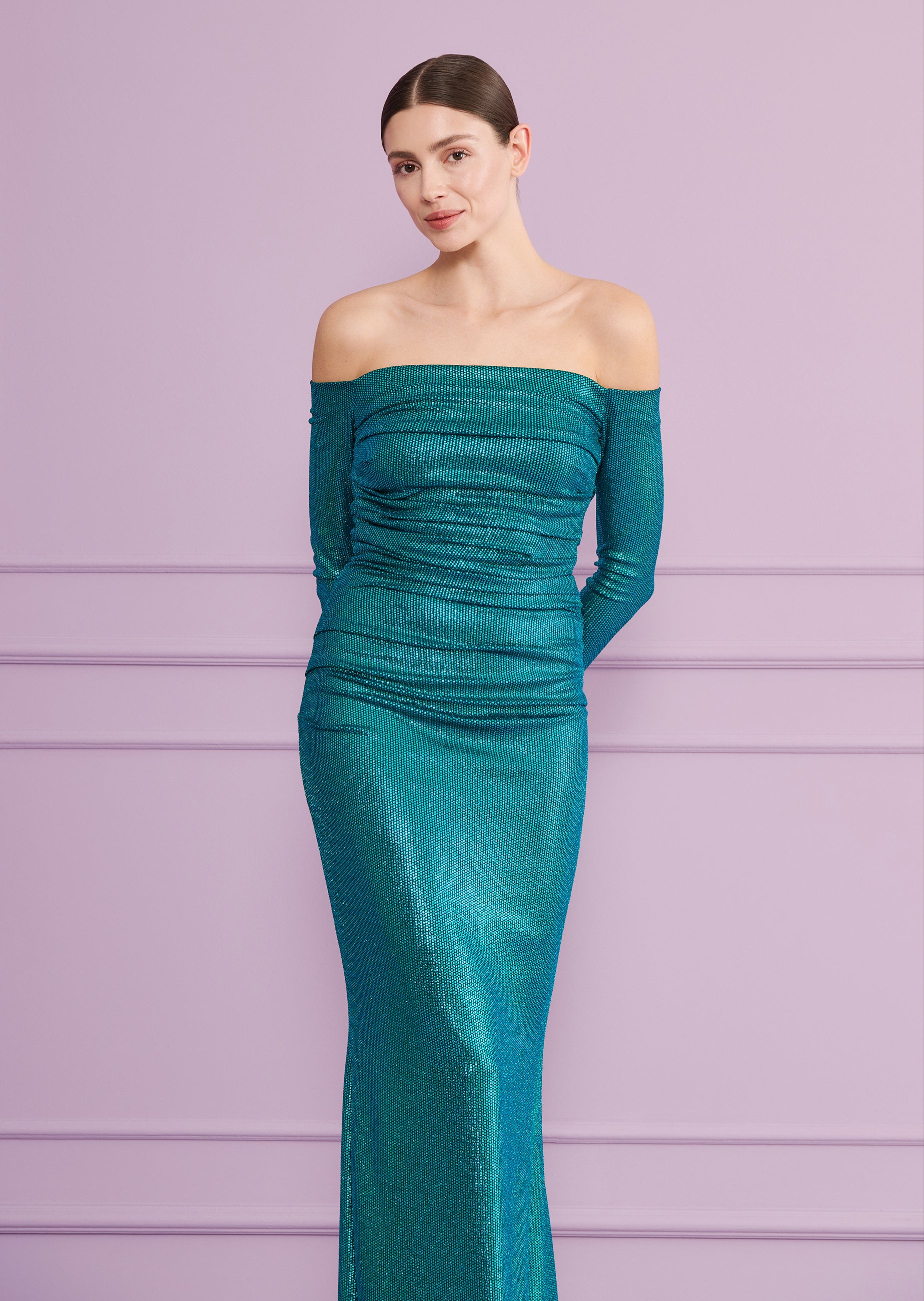 Shimmering teal off-the-shoulder long dress with long sleeves and horizontal ruching on the bodice and upper skirt.