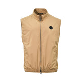 Front view of a men's luxury Stefano Ricci sleeveless zip-up vest in a solid beige color, showcasing a high stand collar, vertical side pockets, an elasticated hemline, and a circular black eagle logo patch on the left chest.