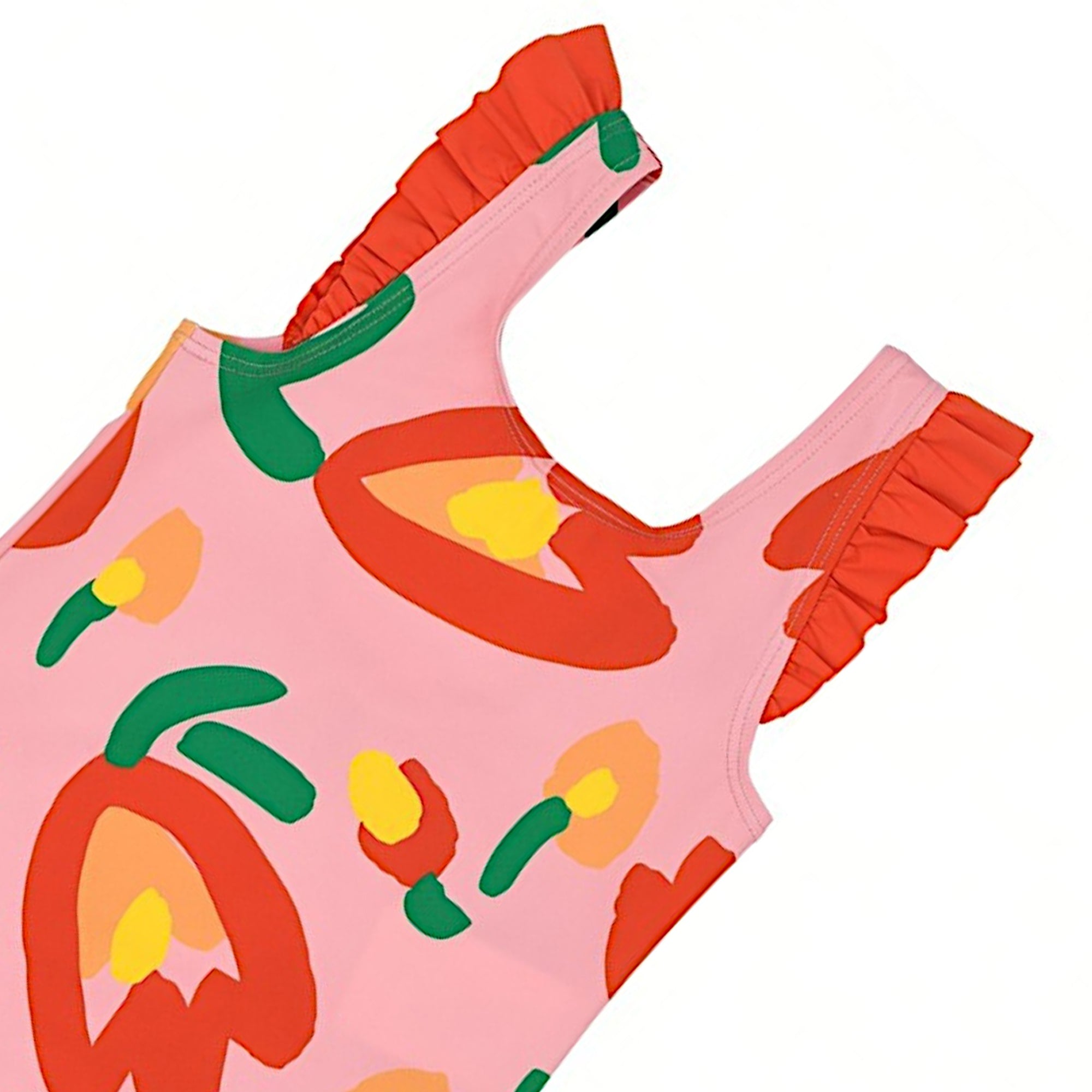 Detailed close-up shot of the shoulder strap on a Stella McCartney Kids pink swimsuit, showcasing the vibrant red ruffle trim and the colorful abstract tulip print.