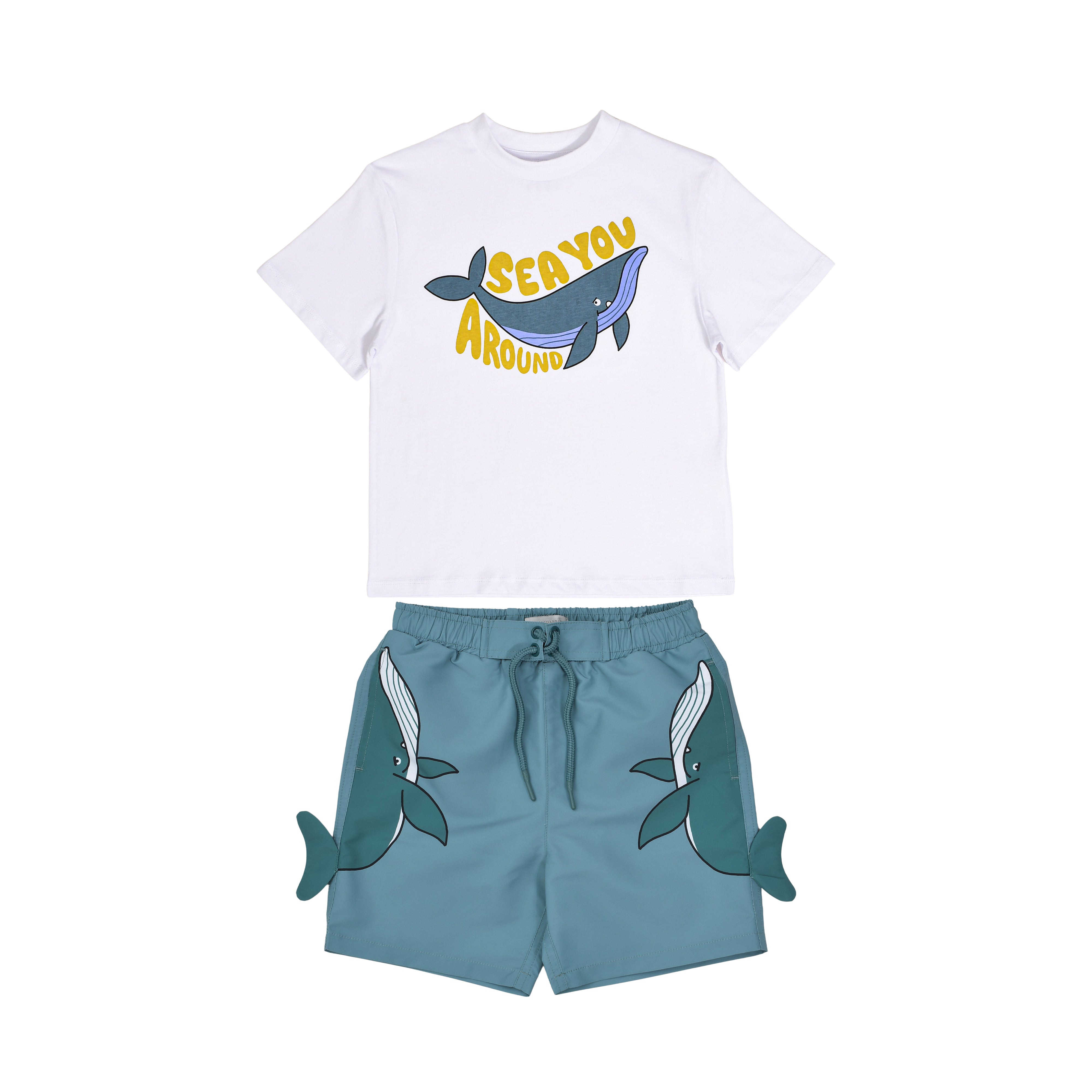 Front flat-lay view of a Stella McCartney Kids two-piece set featuring a white "Sea You Around" whale graphic t-shirt and matching teal shorts with 3D side fins.
