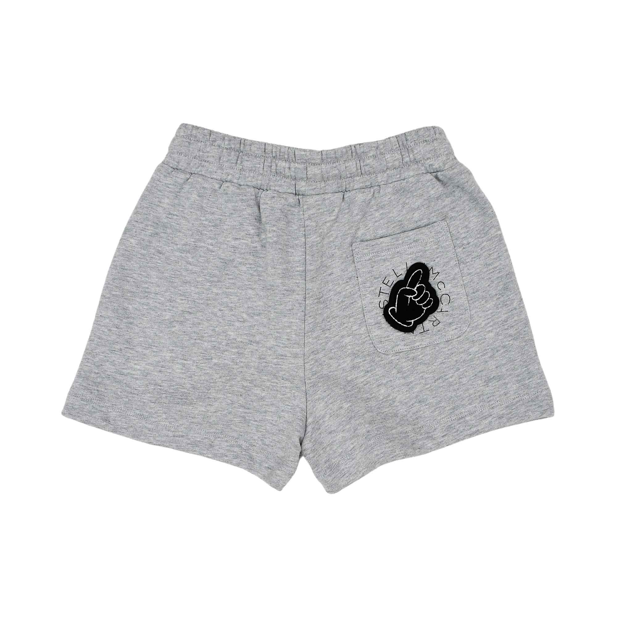 Back view of children's grey marl shorts showing a patch pocket decorated with a black hand-gesture graphic and circular brand logo.