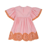 Back view of a pink children's dress showing the keyhole button closure and large orange medallion embroidery on the sleeves and skirt.