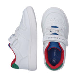 White low-cut sneakers with perforated toes, white laces, a branded Velcro strap, blue tongues, and red and green collar/heel