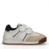 White low-cut sneaker with two velcro straps, beige toe, navy heel collar, and side stripes. Tommy Hilfiger logo on side. Bro