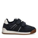 Navy blue low-cut sneaker with two velcro straps, white wavy side trim, white heel collar, and brown rubber sole.