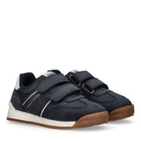 Pair of navy blue and white Tommy Hilfiger Kids low-cut sneakers with brown outsoles and two Velcro straps.