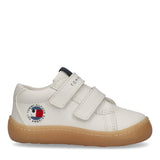 White mid-cut sneaker with two velcro straps, a brown sole, a dark blue heel tab, and a Tommy Hilfiger smiley logo.