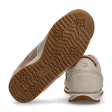 Light pink low-cut sneakers with metallic rose gold side stripes, white midsoles, gum outsoles with star patterns, and brande
