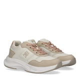 Pair of off-white and nude Tommy Hilfiger Kids low cut lace-up sneakers with chunky white soles and embossed side logos.
