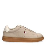 Beige suede low-cut lace-up sneaker with off-white heel trim, small flag logo on side, and brown rubber sole.
