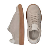 Low-cut beige suede lace-up sneakers with light brown rubber soles and white heel accents. Small flag logo on side.