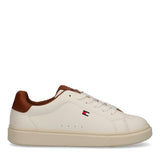 Off-white low-cut lace-up sneaker with cognac brown heel and collar trim, a small flag logo on the side, and an off-white sol