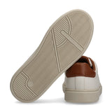 Off-white low-cut sneaker, back view. Cognac heel tab, beige textured sole with 'TOMMY HILFIGER' branding.