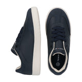 Navy faux leather low-cut lace-up sneakers with white soles, cream collar trim, and Tommy Hilfiger branding.