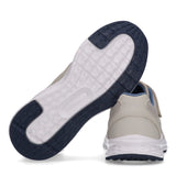 Beige low-cut sneaker with mesh upper, white midsole, and navy blue textured outsole. Features a light blue collar and velcro