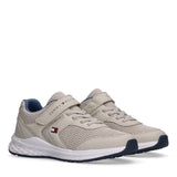 Pair of light beige Tommy Hilfiger Kids low-cut sneakers with mesh upper, white midsole, and navy outsole.