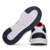 White and navy blue low-cut sneaker, back view. White sole with navy blue textured areas. Red collar lining, white velcro str