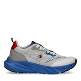 White mesh low-cut trainer with blue sculpted sole, grey overlays, red heel accent, and Tommy Hilfiger flag logo.