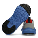 Trainer with a blue and black sculpted, textured sole. The heel is grey and white with a red fabric strip and navy pull tab.