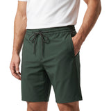 Side-angle shot of a model wearing the Tombolini dark green stretch shorts, demonstrating the secure side pocket and premium athletic fit.