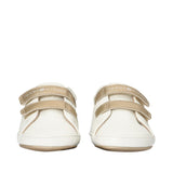 Pair of off-white low-cut sneakers with two gold-toned velcro straps, "TOMMY HILFIGER" branding, and gold-toned soles.