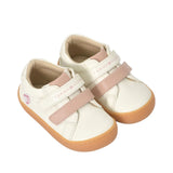 Off-white mid-cut sneakers with two pink velcro straps, pink ankle trim, and brown rubber soles. Tommy Hilfiger logo on strap