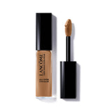 Lancome Teint Idole Ultra Wear All Over Concealer in a clear tube with a black cap and a brown suede-toned applicator.