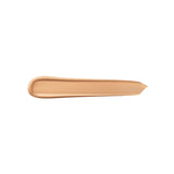 A horizontal swatch of bisque-colored liquid concealer, smooth and creamy, with one rounded end and one feathered edge.