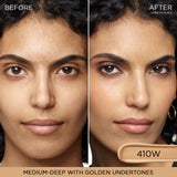 A curved, elongated swatch of medium-deep beige liquid concealer with golden undertones.