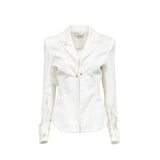 Front close-up view of the Tuba Ergin off-white blazer showcasing sharp notched lapels, structural seams, a delicate gold-tone front closure, and semi-sheer lace panels on the forearms.
