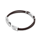 Brown braided leather bracelet with silver-toned open clasp featuring a 'P' logo, rectangular plaque, and two rings with clea