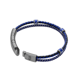 Two-strand bracelet: braided blue/black leather cord and silver-toned beads. Silver-toned clasp with P logo, three blue P-log